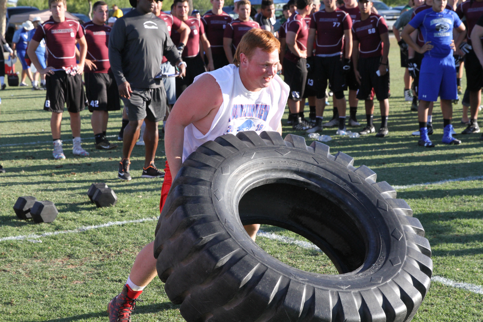 Football player lifts a tire
